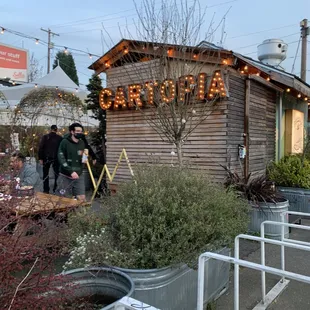people standing outside of a restaurant