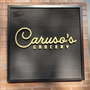 a sign on a brick wall