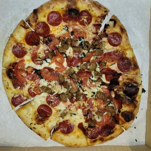 Shy on toppings and dough. You can see  by the size of the slices this pizza is no giant and no thick dough. So small slides around in bix