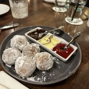 Fried donut dessert with dipping sauces