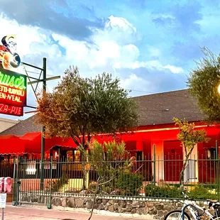 a red building with a neon sign