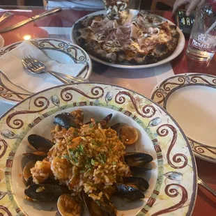Seafood risotto special and prosciutto and mushroom pizza.