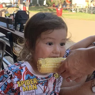 My nephew wanting bite of my corn after he saw me indulging on it!