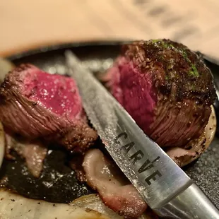 Perfect medium rare served on a sizzling platter with onions.