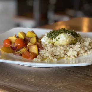 Pan-seared cod basted in garlic butter and topped with chermoula atop a lemony couscous. Served with yellow squash, cherry tomato and onion.