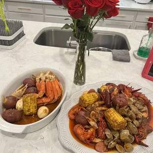 crab legs, potatoes, corn, and corn on the cob