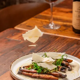 a plate of food and a glass of wine
