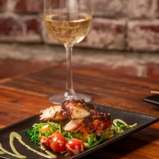 a plate of food and a glass of wine