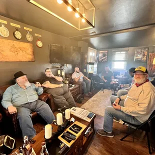a group of men sitting around a table