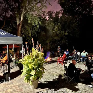 a group of people sitting under a tent