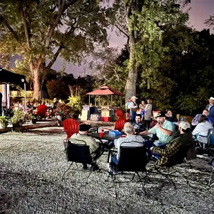 a group of people sitting in lawn chairs