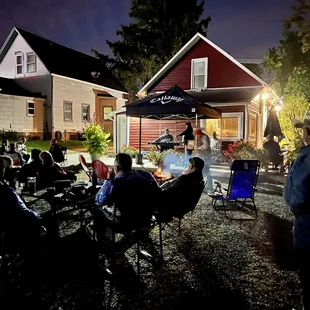 a group of people sitting around a fire pit
