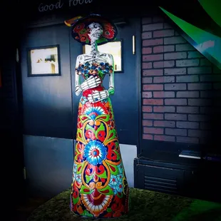 a brightly colored statue of a woman
