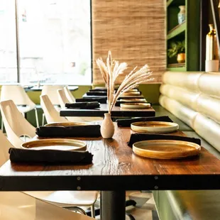 a long wooden table with plates on it