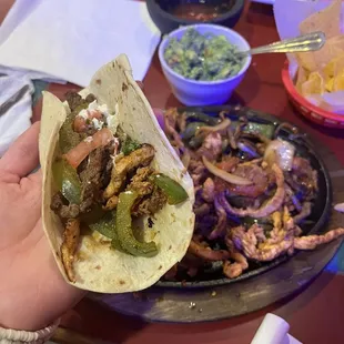 a person holding a tortilla