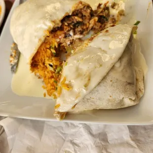 a burrito cut in half on a plate