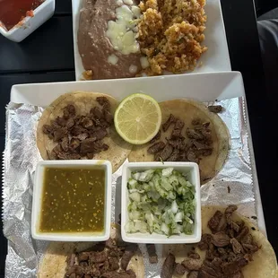 Street tacos with steak, cilantro, rice and beans