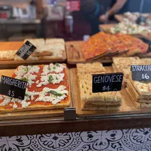 a variety of pizzas on display