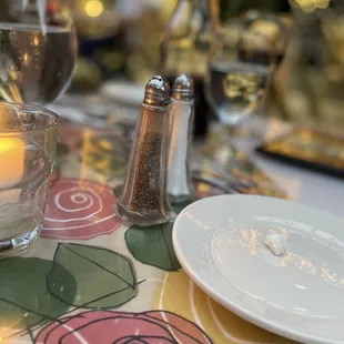 a table setting with salt and pepper shakers