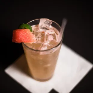 a drink with ice and a slice of watermelon