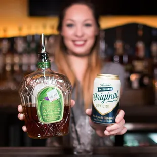 a woman holding a bottle of tequila