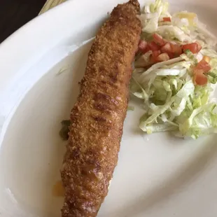 a fish fillet with a side salad