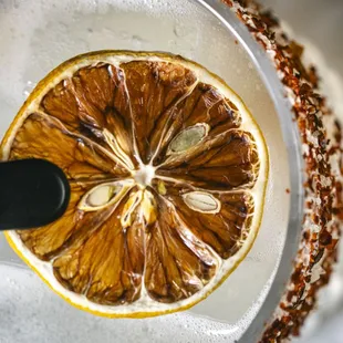 an orange slice in a glass of water