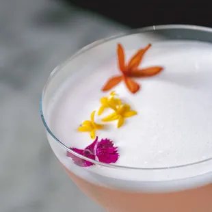 a close up view of a cocktail in a coupe glass