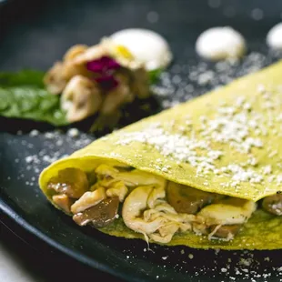 a crepe with mushrooms and cheese