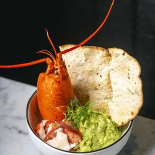 a lobster and guacamole in a bowl