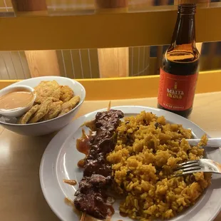 Arroz con gandules, pollo Al pincho, and a side of tostones. A classic in every Puerto Rican household.