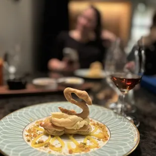 a plate of food and a glass of wine