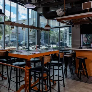 a view of a bar with stools and tables