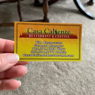 a hand holding a business card