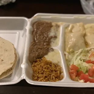 White chicken enchiladas with spicy white sauce and queso.