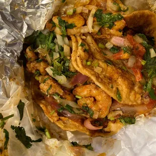 a chicken taco wrapped in foil