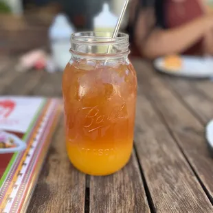 a jar of orange juice on a table
