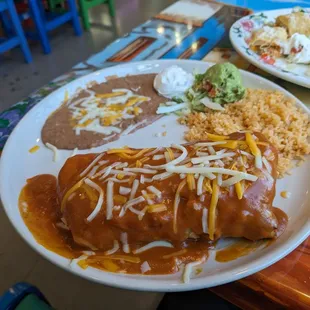 Pork carnitas chimichanga "wet style" with beans and rice