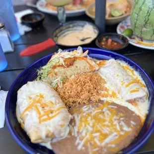 Three item plate. Birria crunchy taco, Ground Beef Chimichanga, &amp; Chicken Enchilada with creamy white sauce. Delicious.
