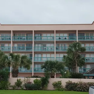 Front of Casa condominiums. Palm trees over pool area.