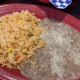 Two plates of beans and rice that come with the molcajete!