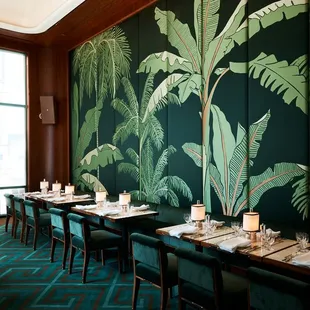 a dining room with a wall mural