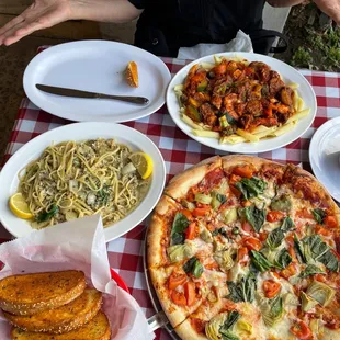 Tomato artichokes pizza and small clam linguini lunch.