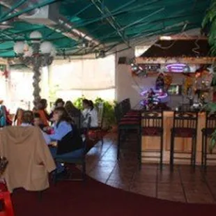 people sitting at tables in a restaurant