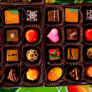 A collection of our 12 piece bon bond with flavors of vegan mango, spicy chipotle caramel, canela sweet ganache, rose petal, and cajeta.