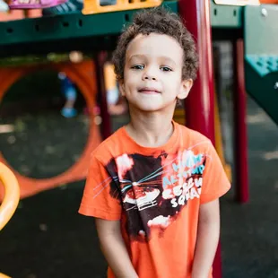Child playing on the outdoor playground.