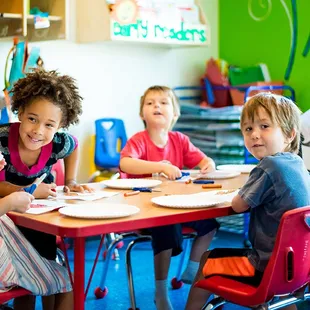 Children making friends in the classroom.