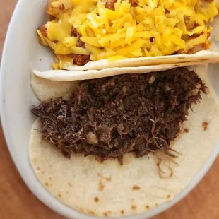 Barbacoa and Bobcat (chorizo egg bacon and cheese) breakfast tacos homemade tortillas.