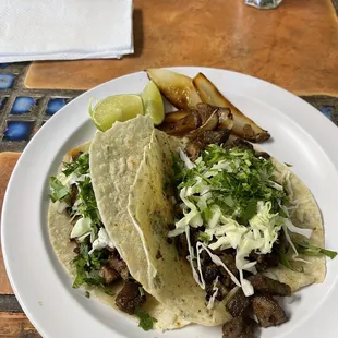 Asada tacos. I got flour tortilla instead of corn. (Which was homemade)!