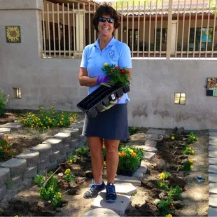 Susie Huhn, Executive Director of Casa de Los Niños was planting flowers this morning. How awesome is that! Thank you.